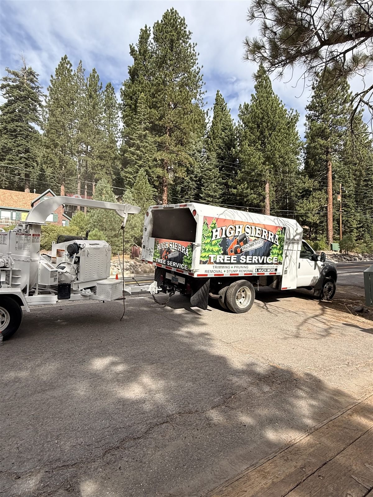 High Sierra Tree Service work truck and wood chipper on a job site in Reno, NV